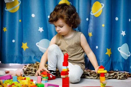 Little autistic boy playing with cubes at homeの写真素材