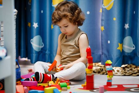 Little autistic boy playing with cubes at homeの写真素材