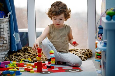 Little autistic boy playing with cubes at homeの写真素材