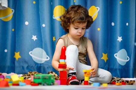 Little autistic boy playing with cubes at homeの写真素材