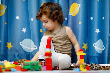 Little autistic boy playing with cubes at homeの写真素材