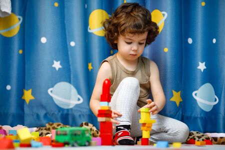 Little autistic boy playing with cubes at homeの写真素材