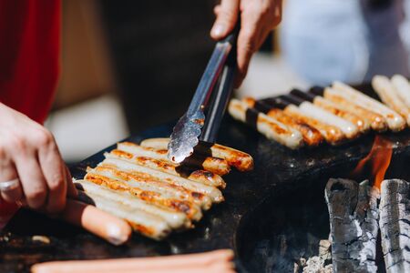 appetizing juicy chicken sausages on the grill close-up.の写真素材