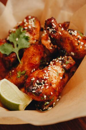gorgeous baked chicken wings on a plate close-up.の写真素材