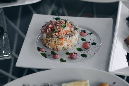 Russian traditional salad Olivier with vegetables and meat. Salad on a plate.の写真素材