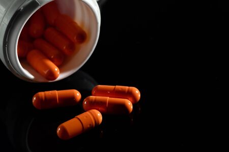 Pharmacy background on a dark table. Levitation pills. Tablets on a dark background which falling down. Pills. Medicine and healthy. Close up of capsules. Pills falling on black background&の写真素材
