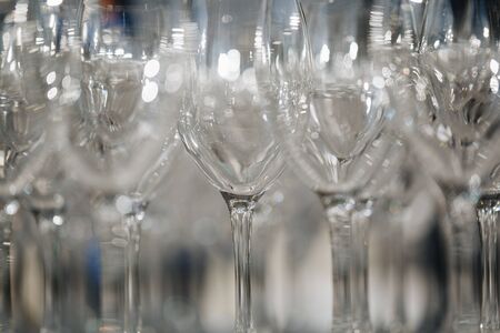Empty wine glasses closeup. In a row, focus on foreground.の写真素材