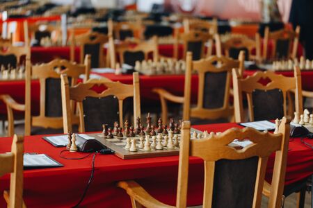 Chess pieces on a boart ready to play a game. Wood pieces of a game of chess on a board.の写真素材