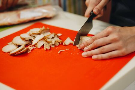 Female Hands Chopping Vegetables On A Wooden Board.の写真素材