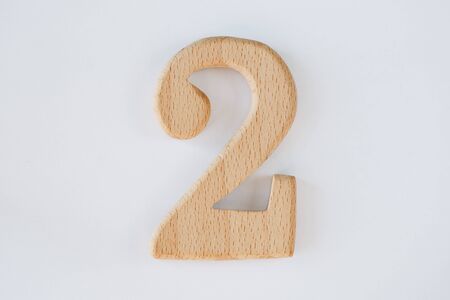 wooden figure number two isolated on white backgroundの写真素材