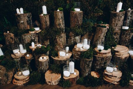 multiple candles set on tree stumps for wedding decor.の写真素材