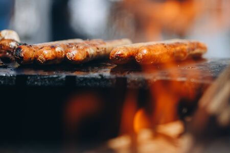 appetizing juicy chicken sausages on the grill close-up.の写真素材