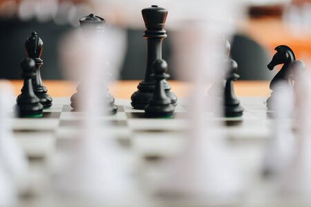 Chess pieces on a boart ready to play a game. Wood pieces of a game of chess on a board.の写真素材