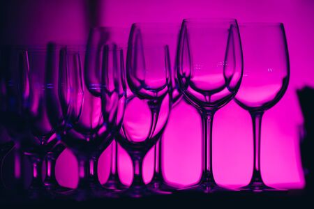 silhouettes of empty glasses on a pink purple background.の写真素材