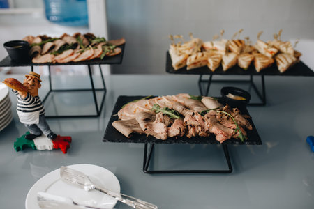 Beautifully decorated catering banquet table with different food snacks and appetizers on corporate...