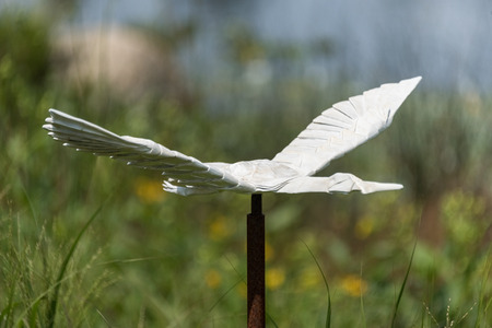Big origami crane in a botanic gardenの写真素材