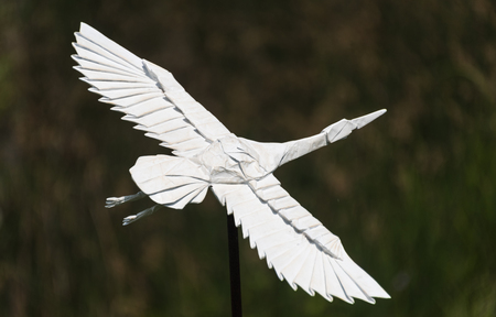 Big origami crane in a botanic gardenの写真素材