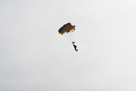 Parachutist in the sky on a cloudy dayの写真素材