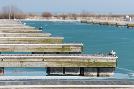 Wooden docks on a frozen Michigan Lake in Chicagoの写真素材