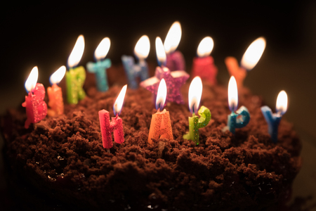 Chocolate birthday cake with candles on itの写真素材