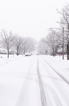 Suburban street covered in heavy winter snowの写真素材