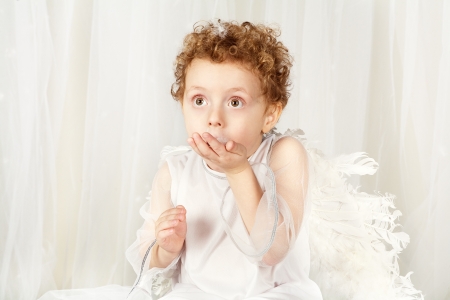 the beautiful little boy in an image of an angel のeditorial素材