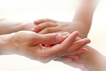 Mother holding a hands of her son