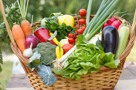 Fresh seasonal organic vegetable in wicker basketの写真素材