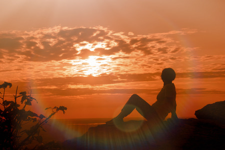 A woman enjoys the sunset and relaxes - enjoying in lifeの写真素材