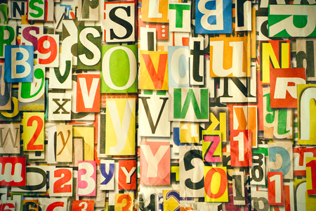 Different alphabet, letters and numbers as background on wallの写真素材