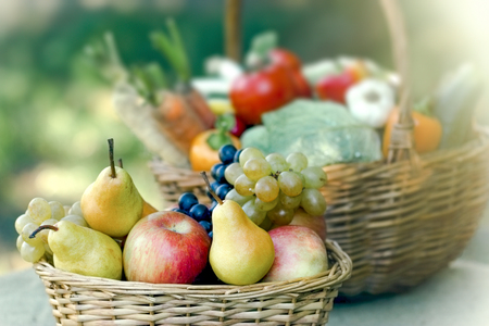 Fresh and healthy food in wicker basket - organic fruit and vegetableの写真素材
