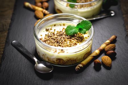 Delicious cheesecake creamy with hazelnut, almond, walnut, and peanut closeupの写真素材