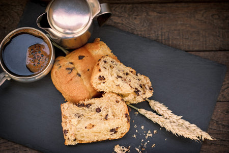 Delicious meal, panettone and black coffee on plate