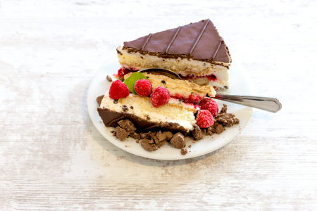 Raspberry cheesecake cake, raspberry creamy cake with chocolate and truffle on white plate