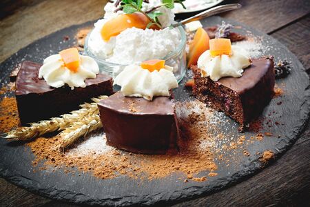 Chocolate cake with apricot, apricot jam - marmalade and whipped creamの写真素材