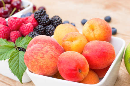 Fresh seasonal fruit in a bowl, healthy vegetarian food on tableの写真素材