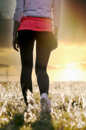 Walking and enjoying the sunset in the meadow, walking in nature is a care for maintaining health,...