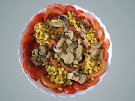 Nice mediterranean salad, with tomato, peas, mushrooms and tunaの写真素材