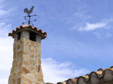 stone chimney with weathervaneの写真素材