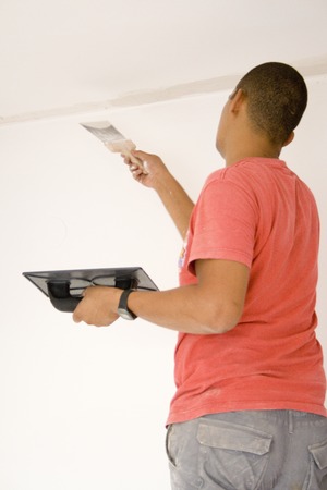 Worker repairing the ceiling with plaster. With some noise.の写真素材