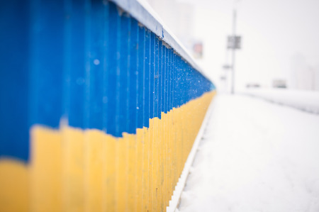 Patriotic Ukrainian flag on the bridge rails.の写真素材
