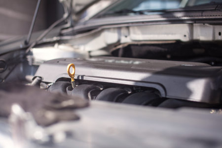Close-up photo of yellow oil dipstick in the car