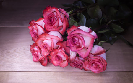 Bouquet whitepink roses on a wooden background.