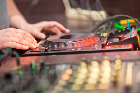 DJ mixing music on console at the night club
