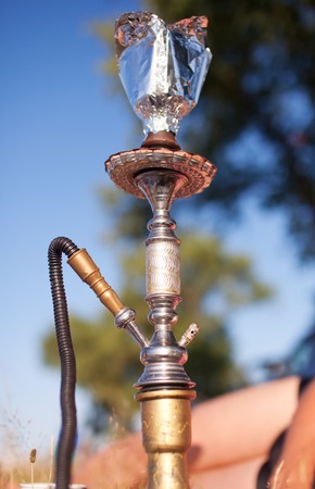 Close-up photo of foil for hookah on nature background.の写真素材