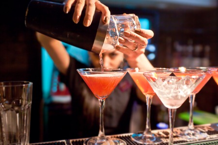 The girl bartender prepares a  cocktail in the nightclub.の写真素材