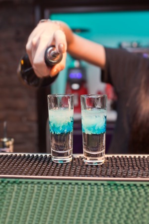 Girl bartender prepares cocktails cloud.の写真素材