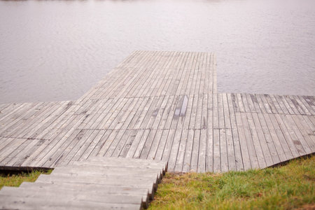 Wooden bridge that goes to the river.の写真素材