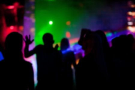 Silhouettes of people dancing  in nightclub at a party.