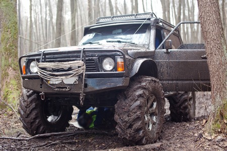 Jeep pulls the car out of the mud.の写真素材